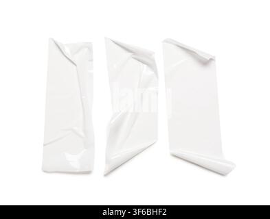 Three pieces of white adhesive tape with curled edges, isolated on a clean white background for design elements, the tape strips are ready for use in Stock Photo