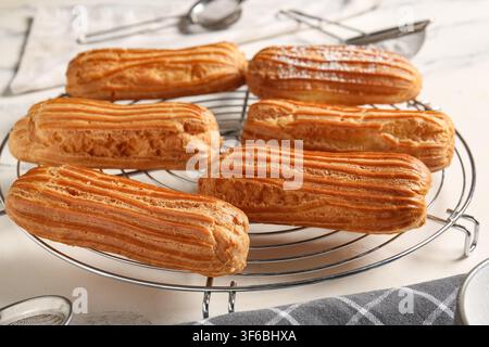 Grid with tasty eclairs on marble background Stock Photo