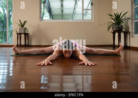 Woman practicing yoga wide angle seated forward bend Stock Photo