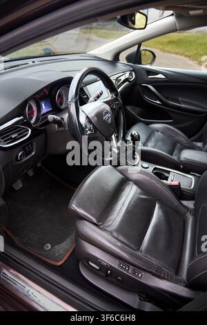 Berlin, Germany - April, 8 2026: Opel Astra K Sports Tourer interior features black leather ergonomic seats, multi-function steering wheel, manual gea Stock Photo