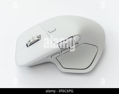 A close up studio shot of a modern ergonomic wireless computer mouse positioned against a plain white background Stock Photo