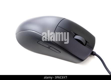 A modern black wired computer mouse rests against a stark white background Stock Photo