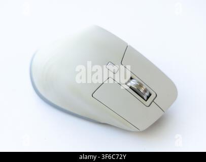 A close up shot of a modern ergonomic computer mouse positioned on a clean white background Stock Photo
