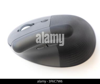 A closeup studio shot of a modern ergonomic computer mouse positioned on a clean white background Stock Photo