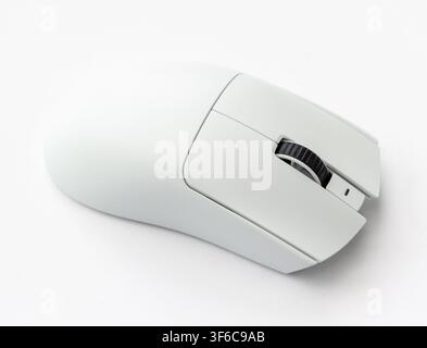 A close up shot of a modern white wireless computer mouse resting on a plain white surface Stock Photo