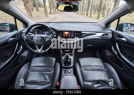 Berlin, Germany - April, 8 2026: Opel Astra K Sports Tourer wagon interior, leather seats, steering wheel, dashboard, multimedia screen, gear shift le Stock Photo