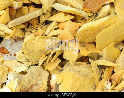 A collection of aged foam rubber pieces lies scattered in a workshop, showcasing the variety of colors and textures developed over time from regular u Stock Photo