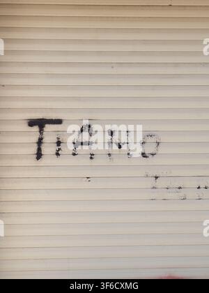Ti Amo graffiti spray painted on a white metal roller shutter, Italian street art declaration of love Stock Photo