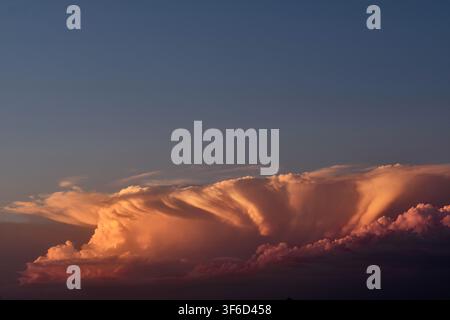 Last sunlight on a small storm front moving in after sunset. Stock Photo