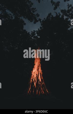 View of a large bonfire burning brightly in the dark forest on Vormsi island in Laane County, Estonia. Stock Photo
