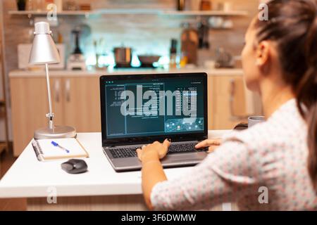 Cybercriminal writes malware on a personal computer as part of an unauthorized attack against network security. Stock Photo