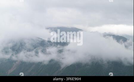 Big clouds covering the mountains. Stock Photo