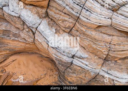 Close-up of layered sandstone and weathered rock textures at Candy Cliffs in Yant Flat, Utah, forming an abstract natural background with warm orange, Stock Photo