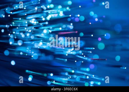Abstract fiber optic technology background featuring glowing blue light trails, luminous strands and soft bokeh. Ideal for data transmission, internet Stock Photo