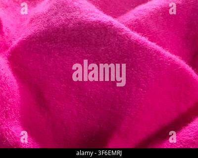 Folded hot pink soft fleece fabric texture background with shadow and depth Stock Photo