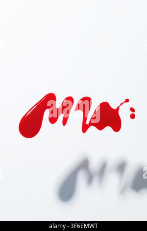 red nail polish drops, nail acrylic gel polish spill Stock Photo