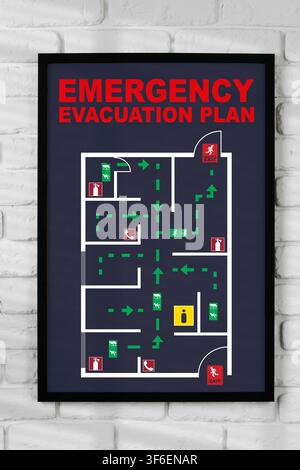 Emergency evacuation plan displayed on a wall showing exit routes and safety information Stock Photo