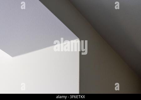 Minimalist architectural detail featuring sharp lines and planes creating a dramatic interplay of light and shade Stock Photo
