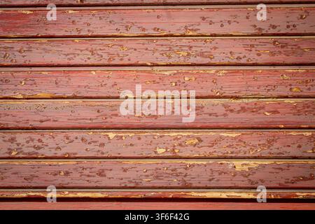 Weathered Red Barn Wood Backdrop with Flaking and Peeling Paint Texture Stock Photo