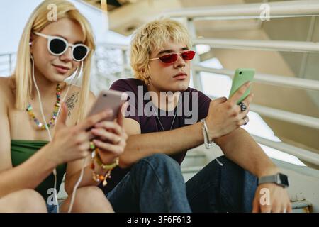 Couple Using Smartphones Outdoors for Social Media Marketing Stock Photo
