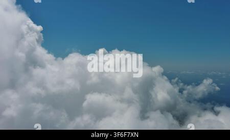 Flying through white fluffy clouds Stock Photo