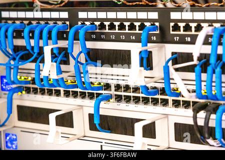 Close-up view of a server rack filled with network equipment and organized cabling for data transmission Stock Photo