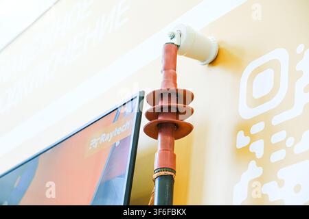 Moscow, Russia, 09.07.2026 High voltage electrical cable termination with rubber insulator mounted on wall display. Power distribution component for u Stock Photo