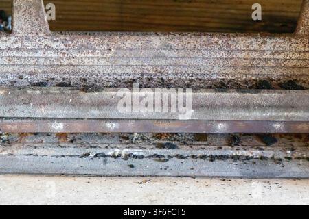 Detailed view of aged, corroded metal layers showing signs of wear, rust, and dirt accumulation Stock Photo