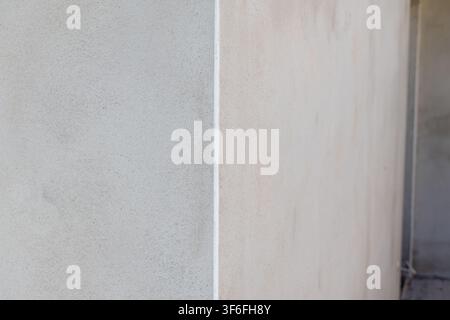 A detailed view of a textured concrete surface, showcasing its granular composition and neutral color palette Stock Photo