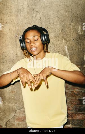Black Man Wearing Headphones and Dancing Outdoors Stock Photo