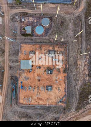 Aerial view of an electrical substation near Cape River, featuring transformers and power lines on a sandy site in a rural landscape, Charters Towers Stock Photo