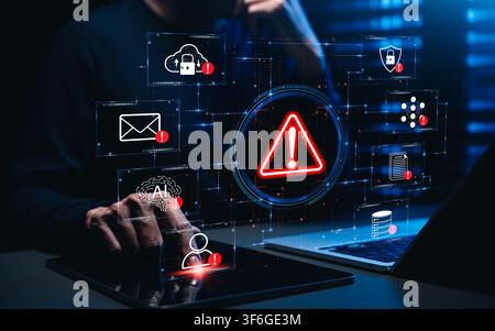 Cybersecurity threat alert concept. Person using laptop and tablet, virtual warning dashboard, cloud security risk, email threat detection, AI monitor Stock Photo