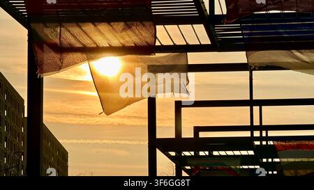 National flags waving in the wind outdoors, creating a colorful travel and cultural background scene. Stock Photo