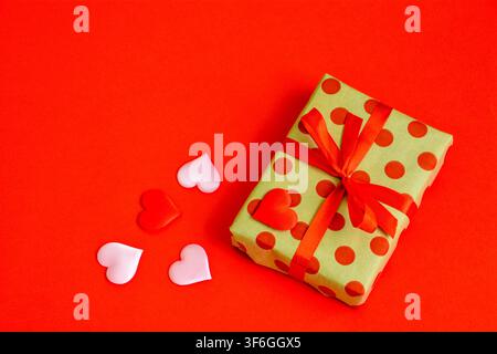 Romantic Gift Box with Red Ribbon and silk red Hearts copy space Stock Photo