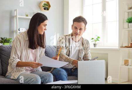 Family Couple Working On Laptop And Managing Finances And Investments At Home Stock Photo