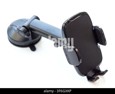 A black plastic smartphone car mount with an adjustable arm and suction cup base sits isolated on a white background Stock Photo