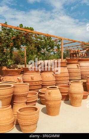 Handcrafted Cretan terracotta pots and large clay amphoras of Minoan design displayed in the traditional village of Margarites, famous for its handmad Stock Photo