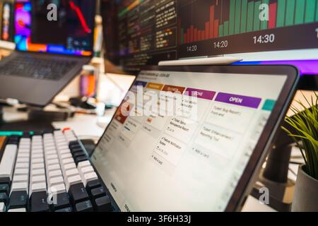 Software Engineer Development Workspace Task Management Screen Mechanical Keyboard. Close up view of a software developer workspace featuring a digita Stock Photo