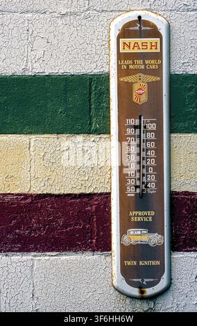 Antique Thermometer on cinder block wall Stock Photo