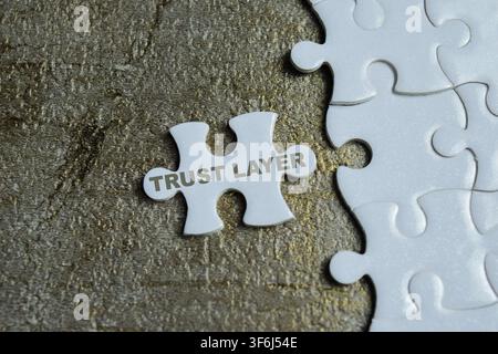 Piece of jigsaw puzzle with word trust layer. For responsible AI and enterprise integration Stock Photo