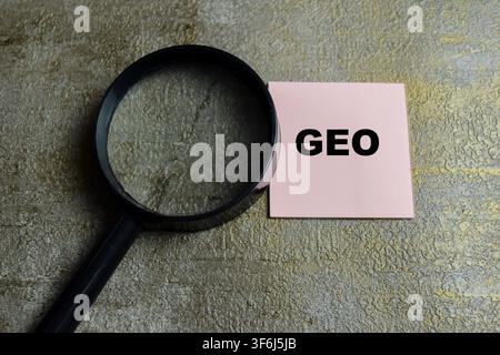 Concept of GEO - Generative Engine Optimization write on sticky notes isolated on Wooden Table. Stock Photo