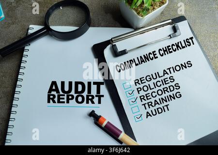 Concept of audit and compliance write on clipboard with business report, checklist isolated on Wooden Table. Stock Photo