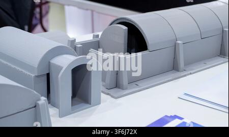 Model of arched shelter printed on 3D printer from molten plastic. Modular design for the protection of critical facilities or personnel created 3D printer. 3D printed scale model mock-up of modular Stock Photo