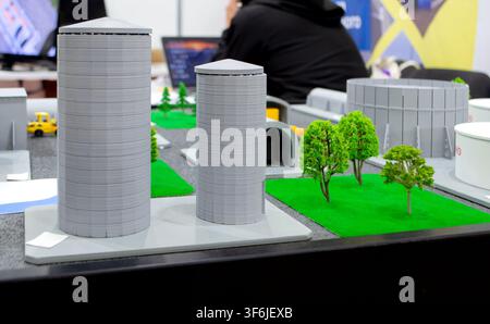Model of reinforced concrete protective shelter made of key blocks created 3D printer from molten plastic. Prototype grain silo or industrial tank made of plastic and other infrastructure. 3D printing Stock Photo