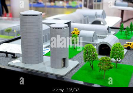 Model of reinforced concrete protective shelter made of key blocks created 3D printer from molten plastic. Prototype grain silo or industrial tank made of plastic and other infrastructure. 3D printing Stock Photo