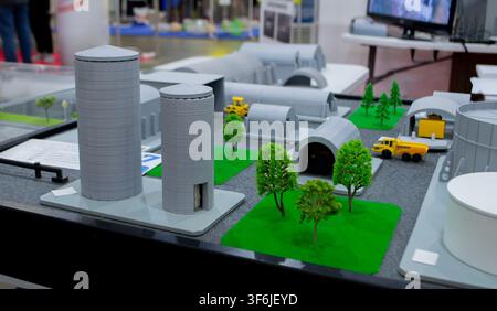 Model of reinforced concrete protective shelter made of key blocks created 3D printer from molten plastic. Prototype grain silo or industrial tank made of plastic and other infrastructure. 3D printing Stock Photo