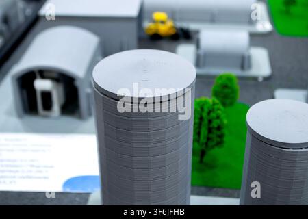 Model of reinforced concrete protective shelter made of key blocks created 3D printer from molten plastic. Prototype grain silo or industrial tank made of plastic and other infrastructure. 3D printing Stock Photo