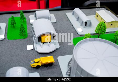 Model of reinforced concrete protective shelter made of key blocks created 3D printer from molten plastic. Prototype grain silo or industrial tank made of plastic and other infrastructure. 3D printing Stock Photo