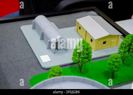Prototype scale models of ground modular shelters printed on 3D printer from molten plastic. Ground-based defensive structures with arched roof and fortified entrances created 3D printer. 3D printing Stock Photo