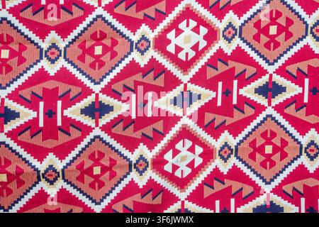 Abstract Background of Ethnic Kilim Rug with Traditional Red Geometric Pattern Texture Stock Photo